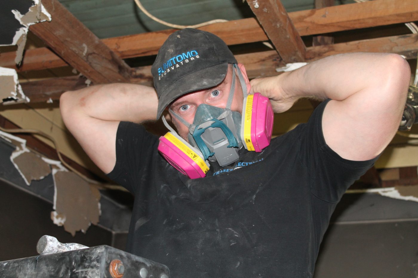 Fraser Electrical technician working in a roof cavity
