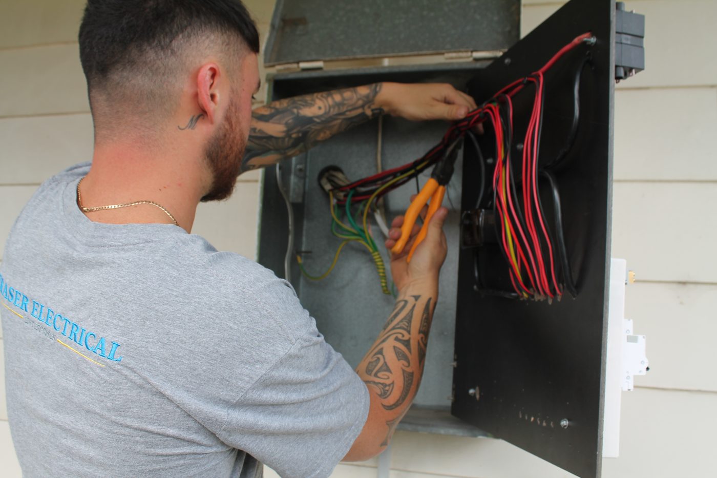 Fraser Electrical technician making a switchboard safe